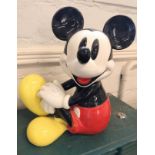 Mickey Mouse wind up music box. This is a ceramic figurine of Minnie Mouse that was created by
