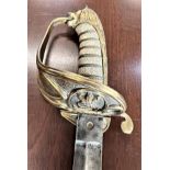 A 19th century Royal Navy Officers Sword. With a gilt-brass hilt of ‘Gothic’ flair forming a half-
