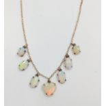 An opal necklace consisting of six polished opals including a heart shaped stone.