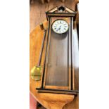 A 19th century. Vienna wall clock. In satinwood with ebonised decoration. Complete with one brass