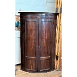 A George III mahogany bow front corner hanging cupboard. Circa 1800. Of good deep colour. 122cm x