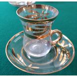 Eleven Turkish coffee glasses and saucers.