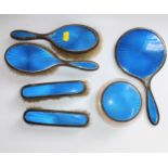 A collection of a lady's silver brush and hand mirror set, decorated in Blue enamel and some