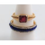 A gold metal ring set with a red stone, size F, & a ring set with blue beads & seed pearls, size M.