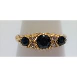 An 18ct gold 3-stone sapphire and diamond ring, size O.