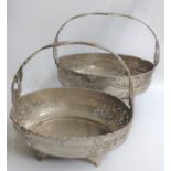 Two silver-plated fixed handle oval baskets decorated in flora and fauna sat on four feet.