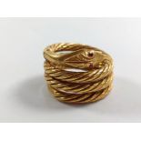 An 18ct gold ring in the form of a coiled snake. Size M