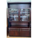 A Mahogany Veneered Display Cabinet. 20th century. The top shelf fitted with two glass doors (two