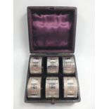 A Cased set of 6 White Metal Napkin Rings with buckle decoration.