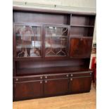 Large Mahogany veneered display cabinet. 20th century. The top shelf above two glass doors (two
