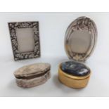 Two pill boxes and two silver colour metal photo frames.