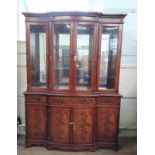 A large mahogany display cabinet. Modern. Fitted with a pair of glazed doors enclosing glass