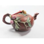 A small Chinese Yixing teapot.