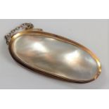 A large Mother of Pearl brooch set in a 9ct gold frame.