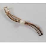 A small 9ct gold bar brooch set with a single pearl.