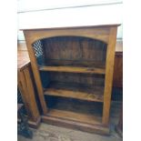 A bookcase. Indian Rosewood with shelves, and wrought iron lattice feature at the sides. 106cm x