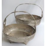 Two silver-plated fixed handle oval baskets decorated in flora and fauna sat on four feet together.