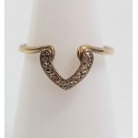 A gold carat gold ring with a diamond set horseshoe forming part of the shank. Size H