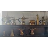 Middle Eastern metalwares including brass ewers and four spare lids. (14)