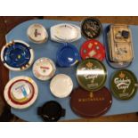 Tinplate pub trays including Carlsberg, Cathay Cocktail and Whitbread, and ceramic ashtrays
