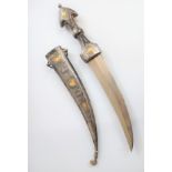 An antique knife, Middle Eastern. The knife is decorated to one side of the scabbard in niello and