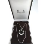 An 18ct white gold chain set with a round diamond, black onyx pendant. The pendant is 3.5cm in