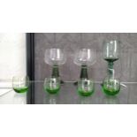 Two Roemer-style glasses with green ribbed stems, a green wine glass with knobbed stem and four