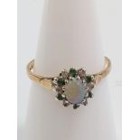 An opal cluster ring set emeralds and diamonds. Size L