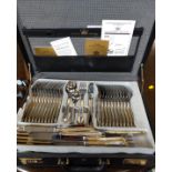 A classic SBS cutlery set, partially gold plated with a cross ribbon decoration. "Besteck Modell