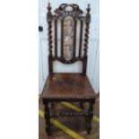A Victorian high-back chair ornately decorated. Seat in need of repair.
