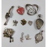 An assorted collection of eleven pendants, brooches and charms.