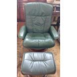 After Charles Eames. A Green leather chair with footstool and leather kit
