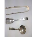 A pair of decorative sugar nips together with a possibly imported plated shovel spoon and a caddy