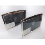 A pair of silver photo frames size 10cm x 18cm with rounded tops, in boxes.