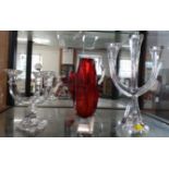 Two Villery & Boch three-branch glass candle holders 30cm and 16.5cm; and red and clear faceted vase