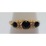An 18ct gold 3-stone sapphire and diamond, size O.