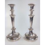 A pair of silver-plated candlesticks, approximately 27cm tall.