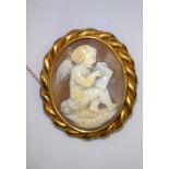 A Victorian shell cameo carving of a cherub encased in a gold colour metal frame. Crack to cameo.