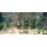 Fifteen green glass items including a square decanted and stopper and a cylindrical jar and