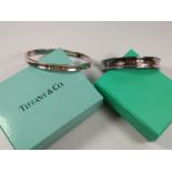 Tiffany two silver bangles, narrow cuff and full round, both boxed