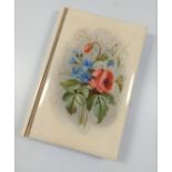 An Edwardian notepad with pencil, the front cover decorated with flowers.