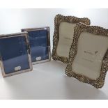 Two boxed silver plate photo frames together with two papyrus crystal set photo frames.
