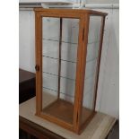 A Showcase shop display cabinet, four glass shelves with ivorine makers label- Dudley & Co. Ltd.