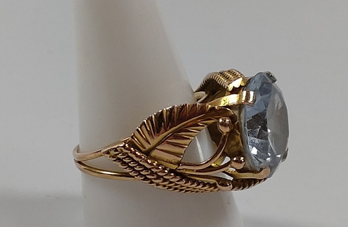 A gold colour metal ring set with a blue stone. Size S. provenance 80 Rose Street Wokingham. - Image 2 of 2