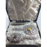 A cased silver brush and mirror set