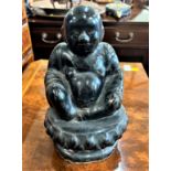 A Vintage Pottery Buddha. Circa 1950. With black glaze. 26cm high. Provenance 80 Rose Street