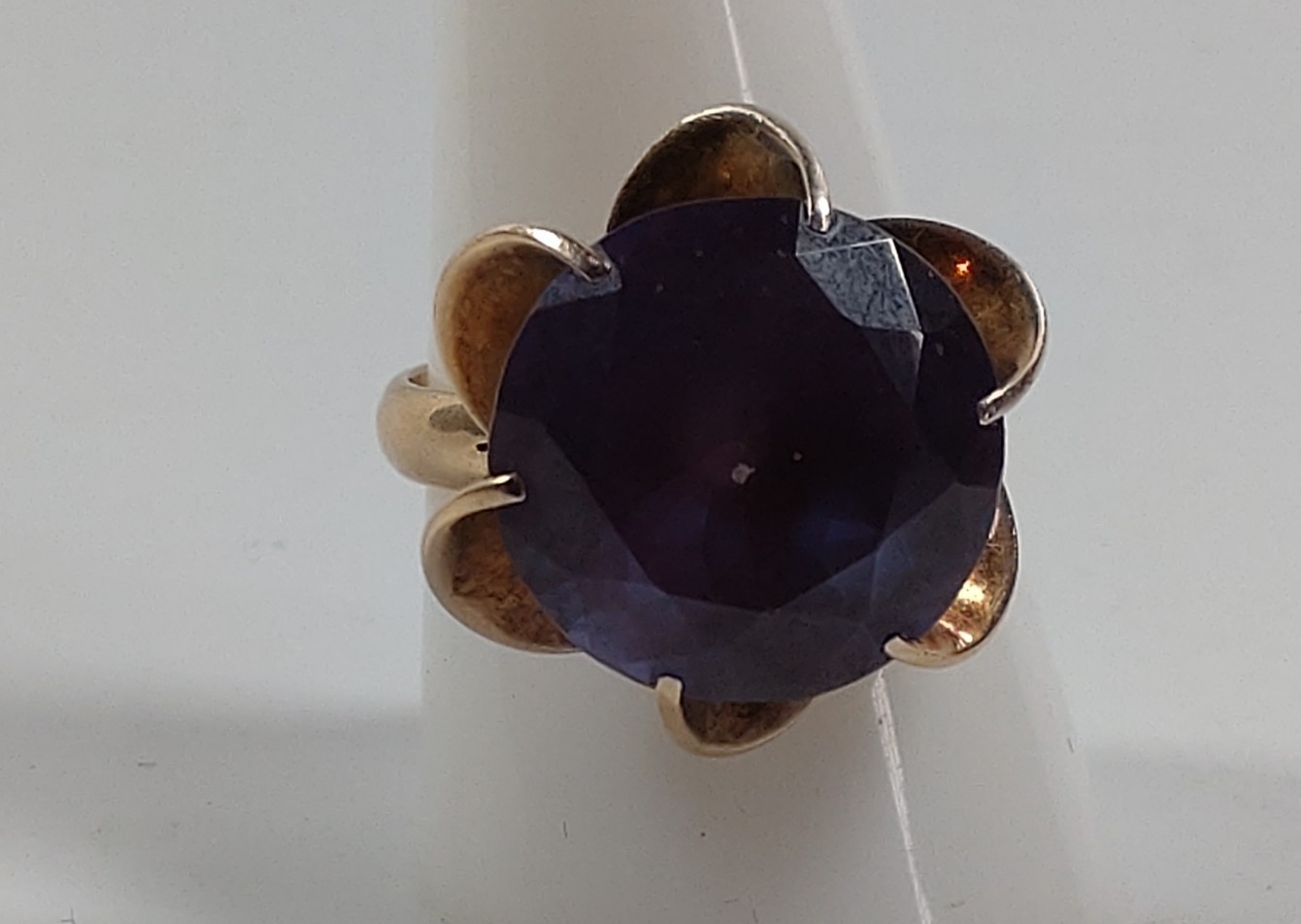 A gold ring marked 14k set with a possible amethyst. Size R. Provenance 80 Rose Street Wokingham.