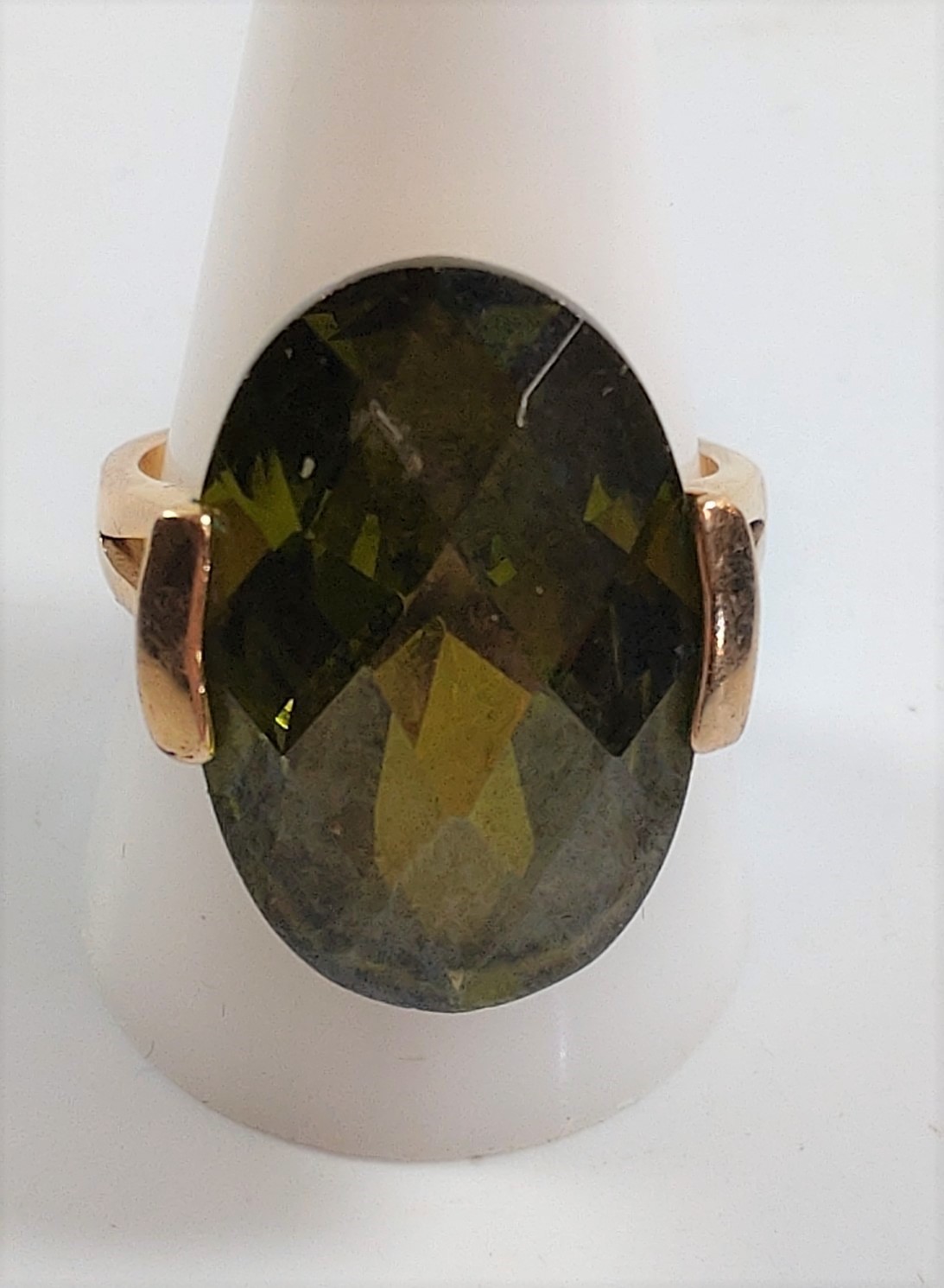 A gold colour metal ring set with possible tourmaline. Size T. Provenance 80 Rose Street Wokingham.