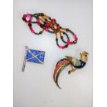A blue and white paste flag, a red glass bow, and a bird brooch. provenance 80 Rose street