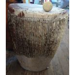An Antique African Tribal Drum. Circa 1900. In carved wood rattan and hide top. With a beater.